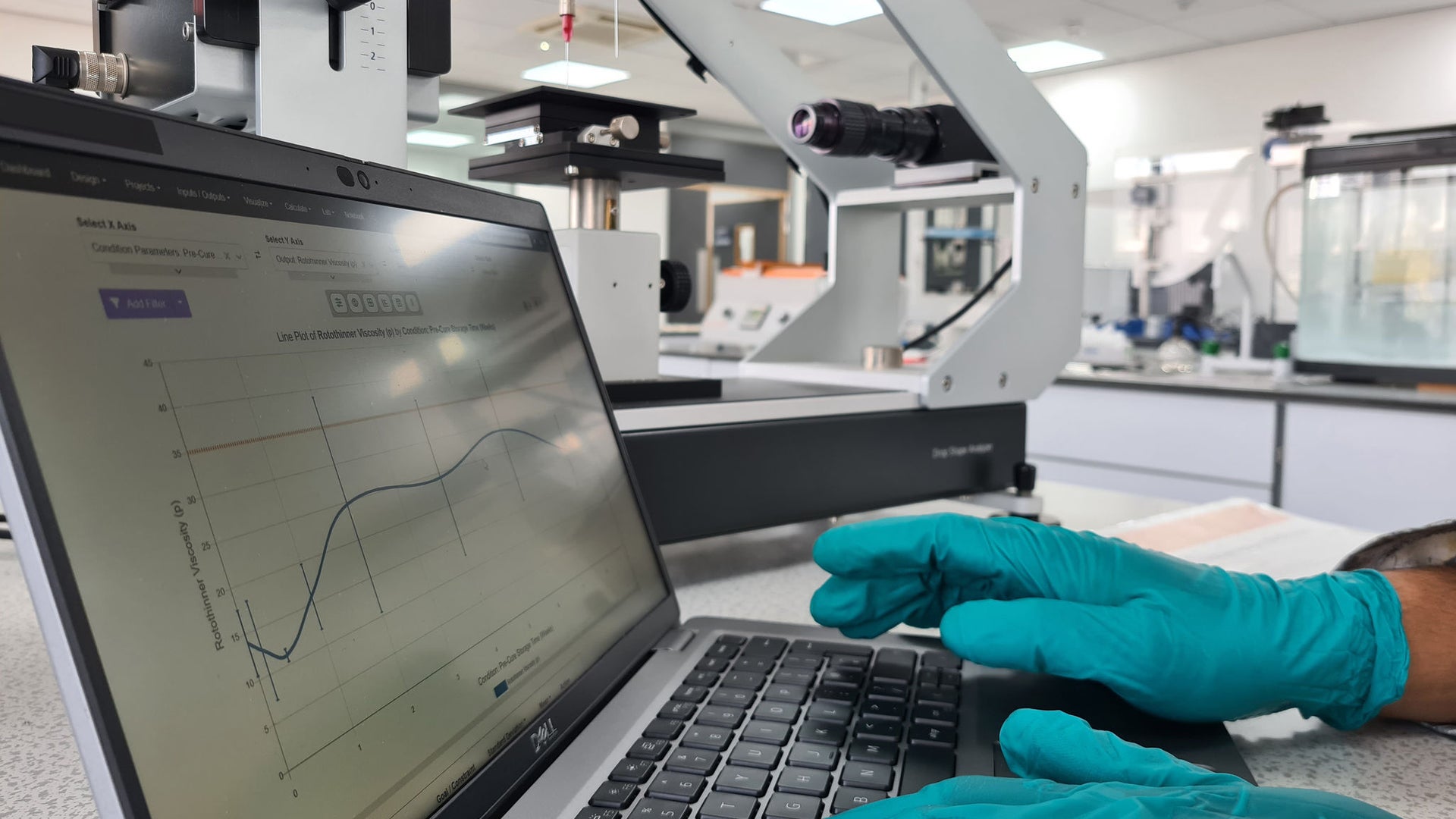 Someone is working on a laptop in a lab.