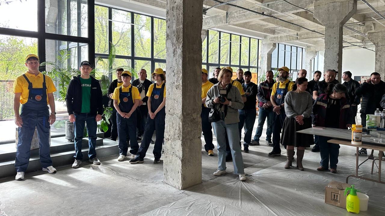 Group of workers gathered in industrial space