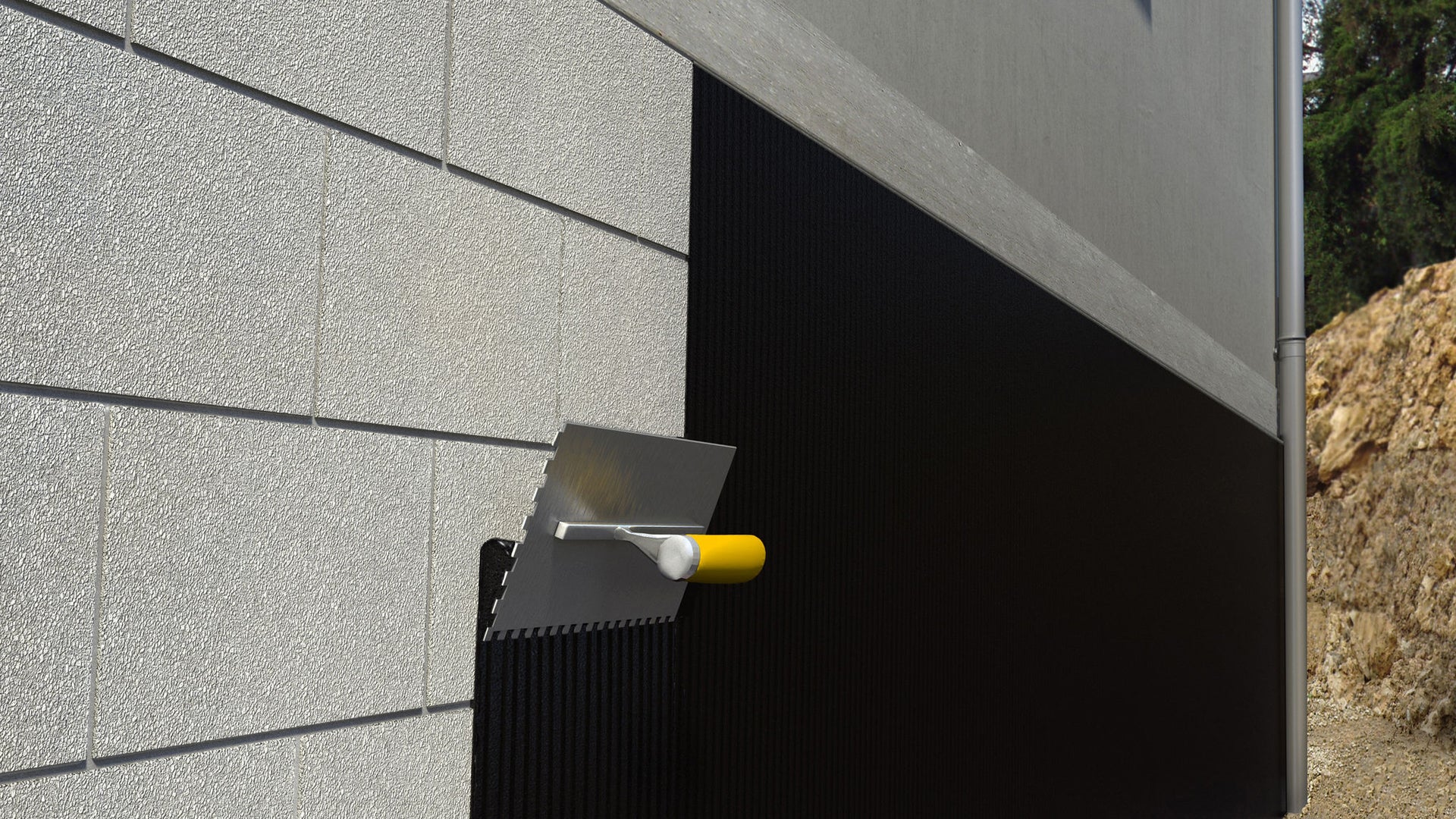 Protective coating is applied to the wall with a trowel