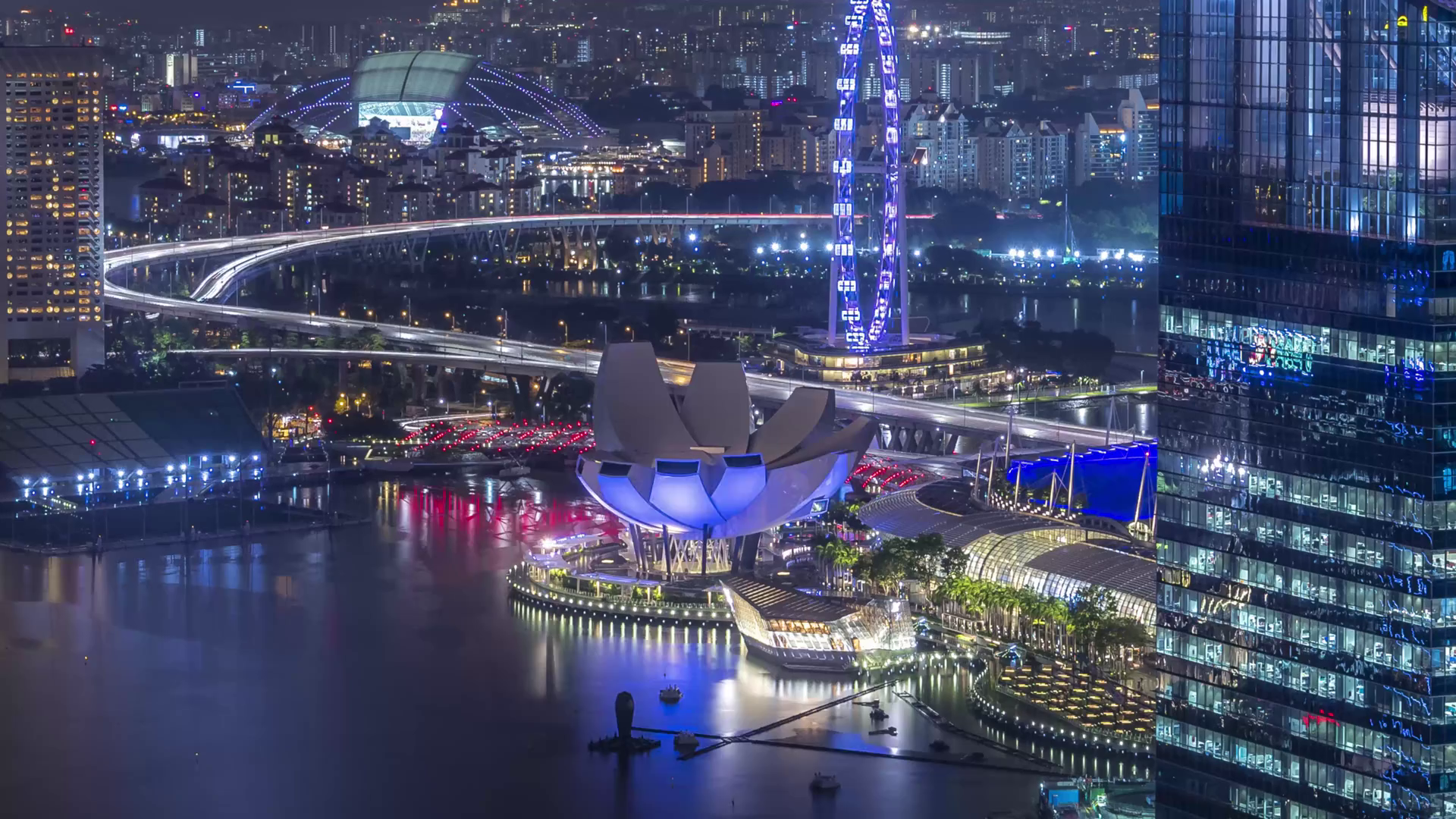 Futuristic waterfront cityscape at night