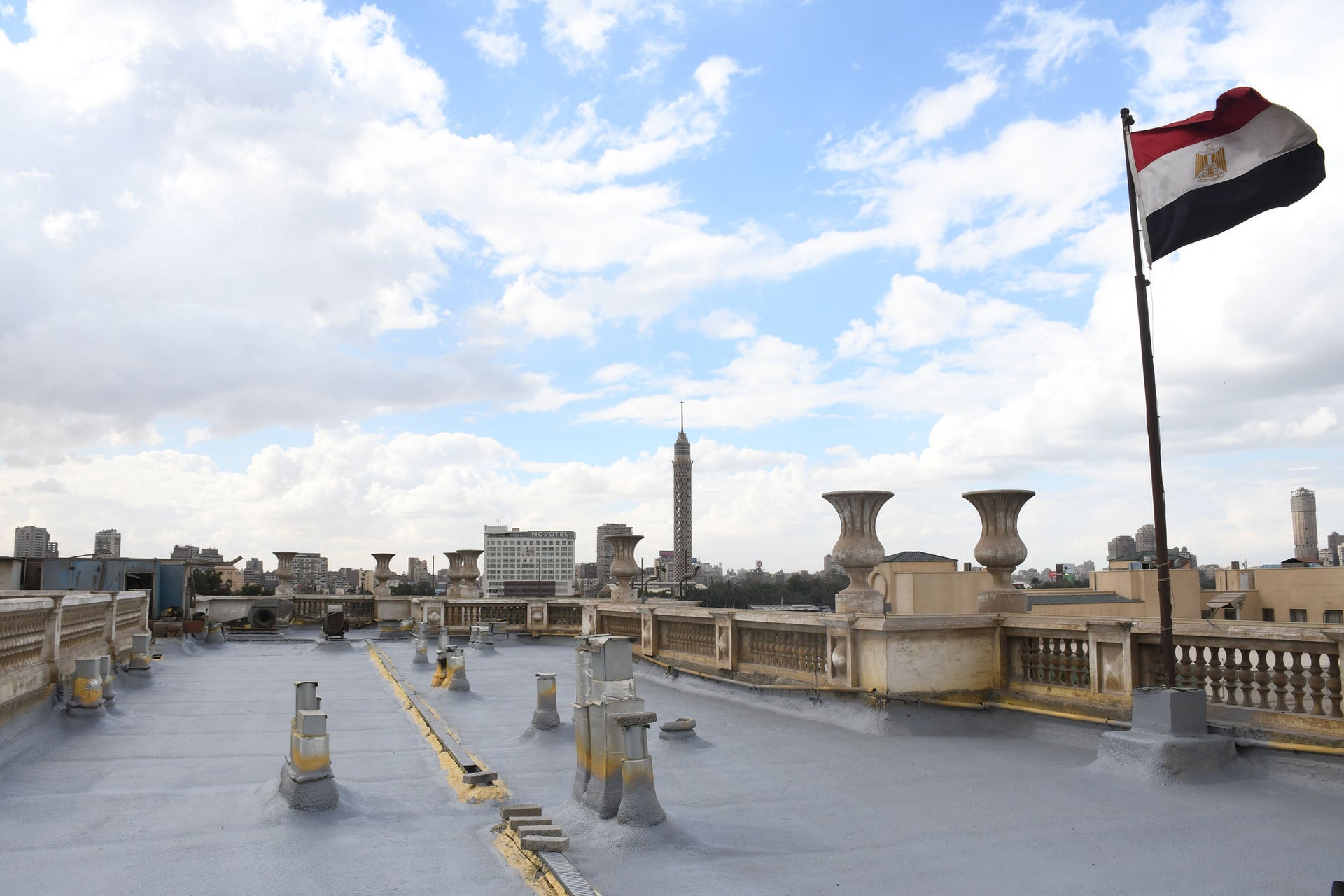 Egyptian Flag on Rooftop Overlooking City Skyline