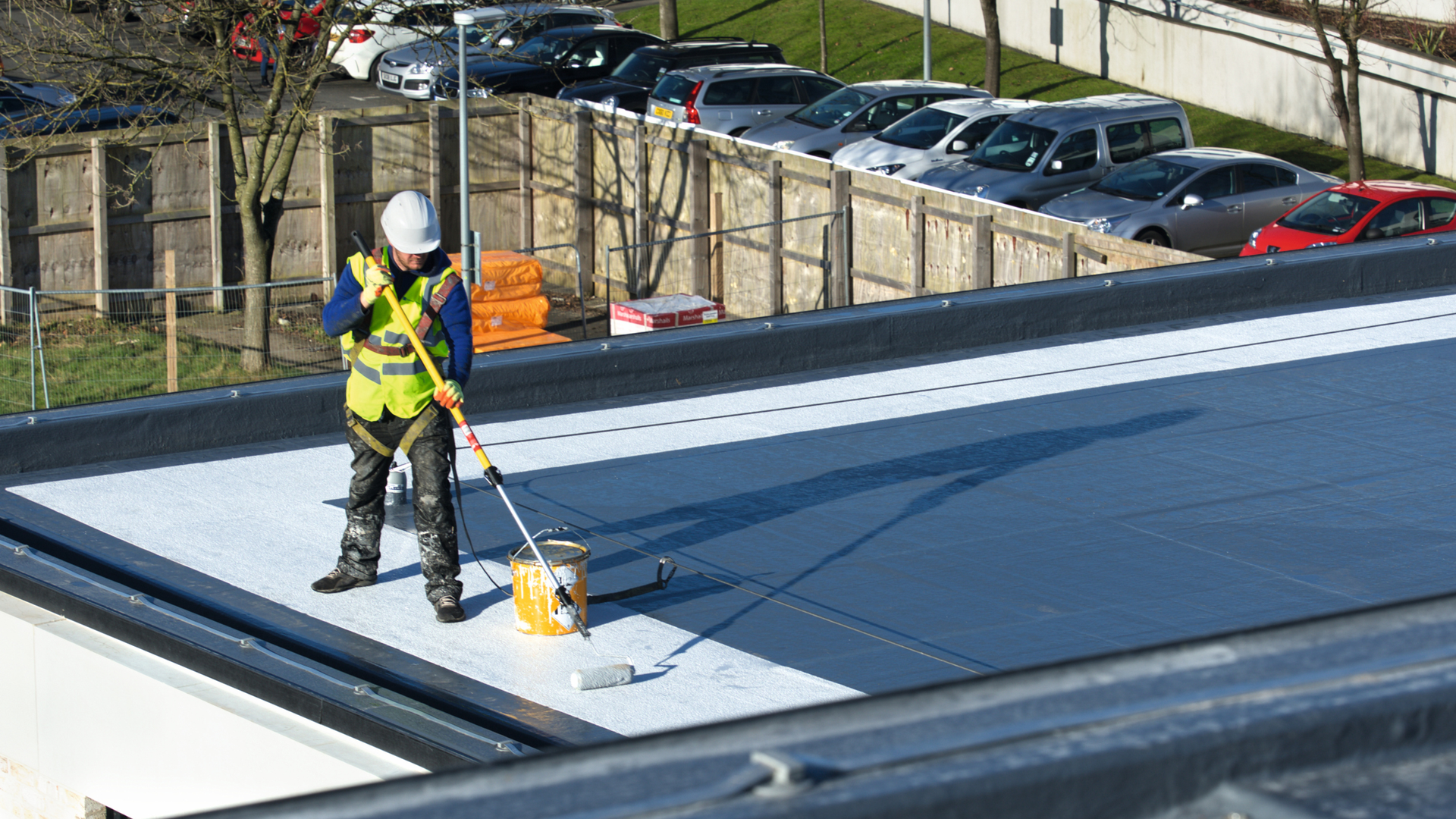 man applying liquid roofing membrane