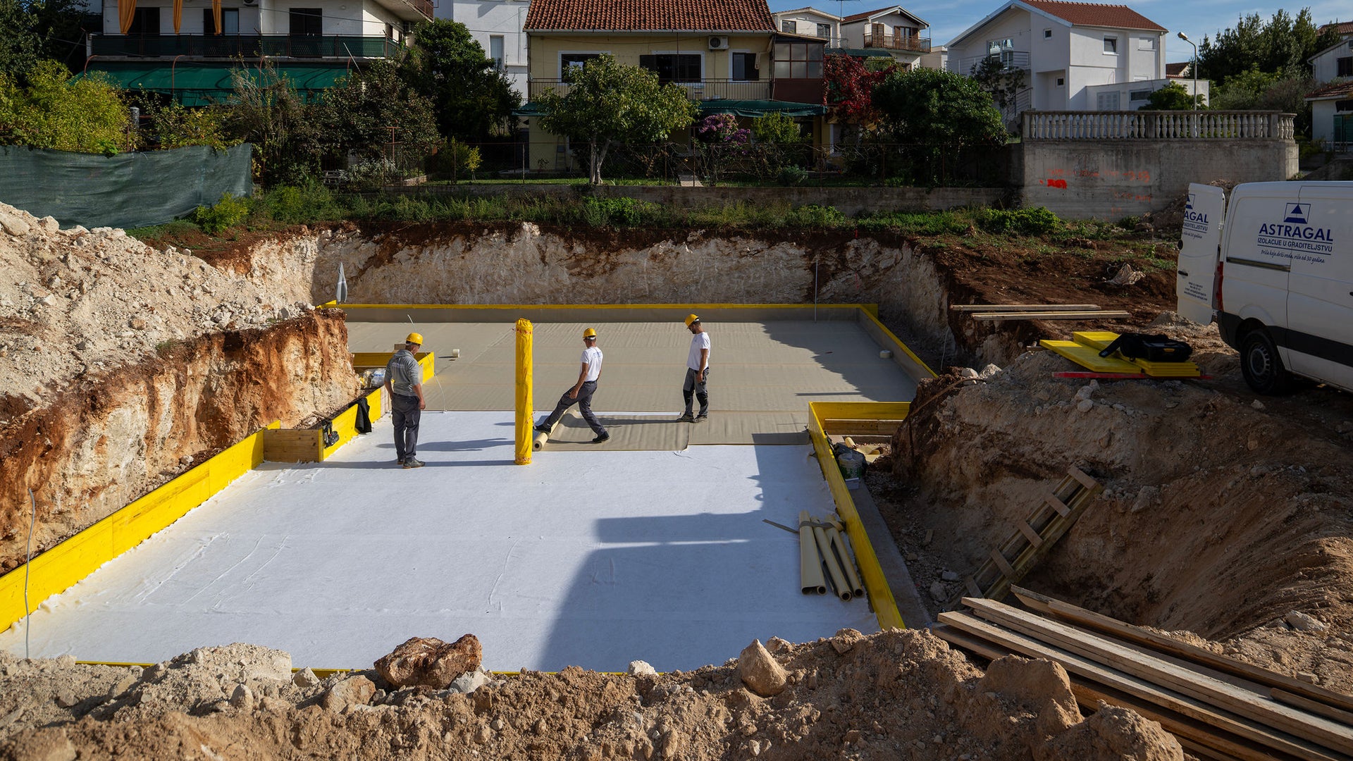 Construction workers preparing foundation site