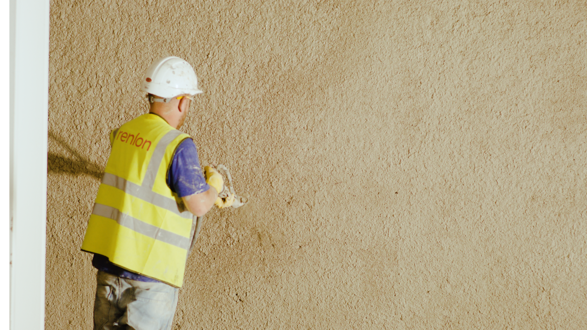 Construction worker applying wall plaster