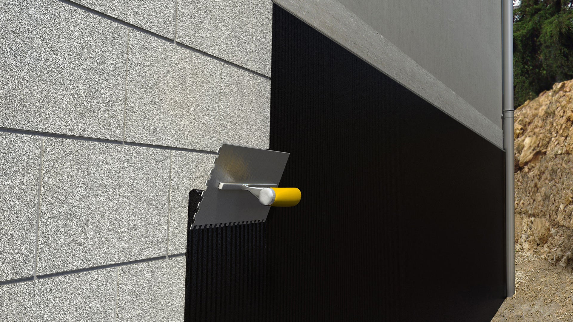 Protective coating is applied to the wall with a trowel