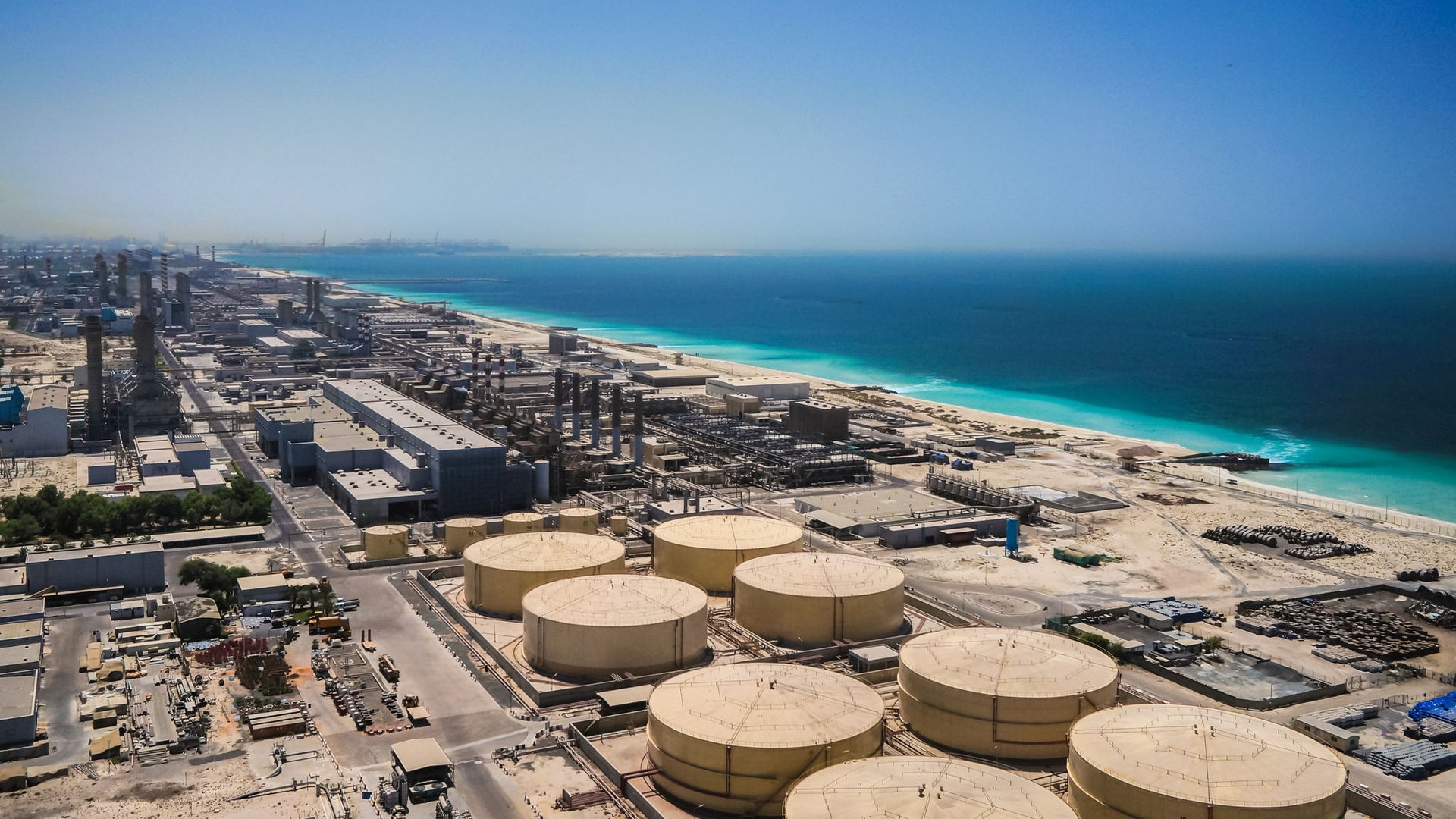 Aerial View of Coastal Industrial Facility with Storage Tanks