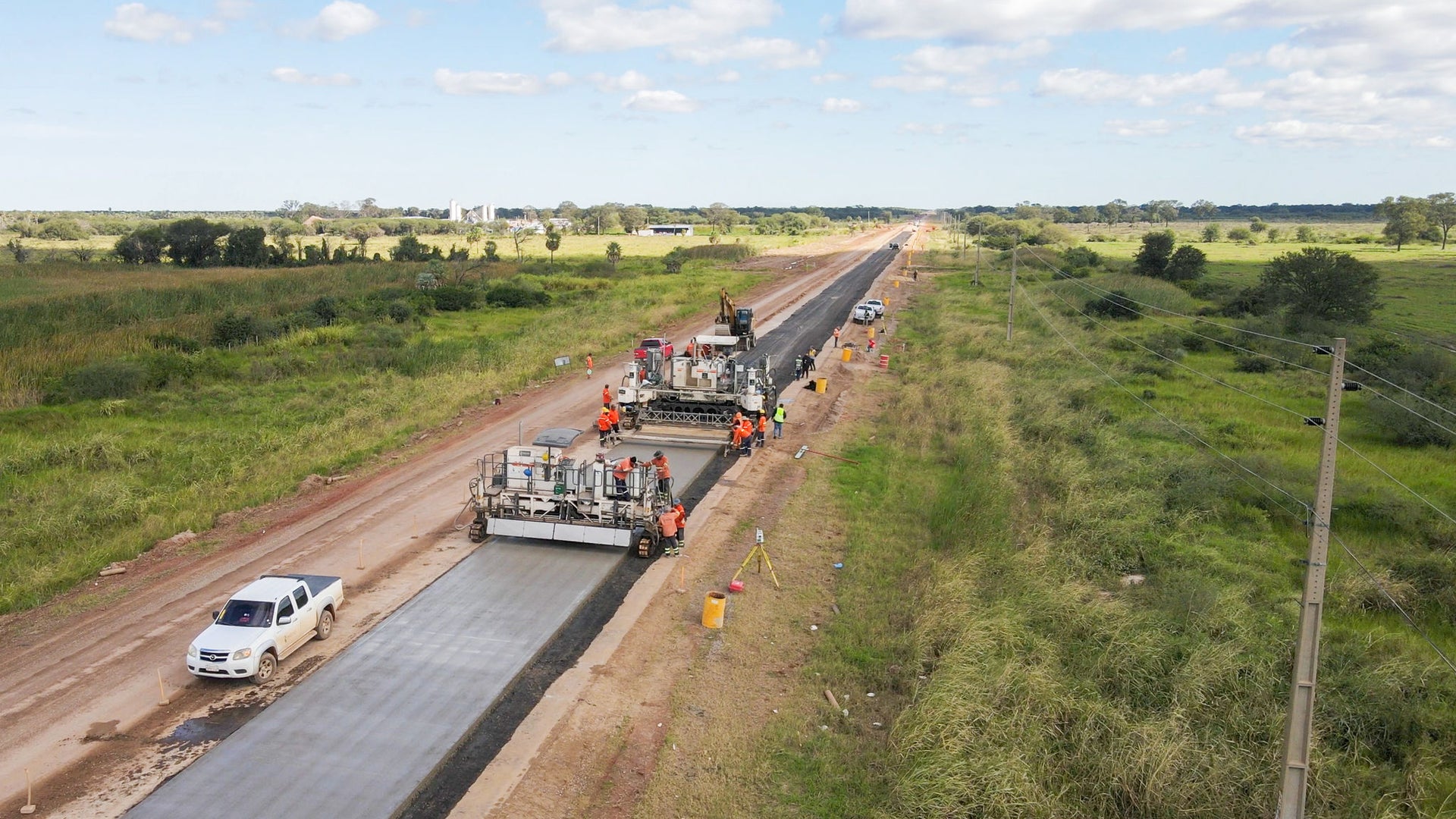 Road construction crew paving rural highway