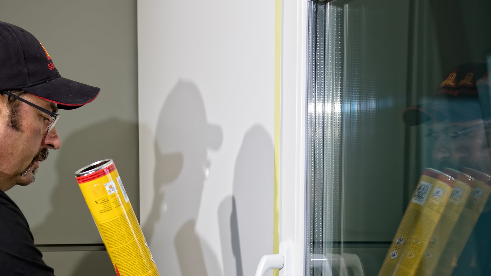 Man applying Sika Boom construction foam at window joint